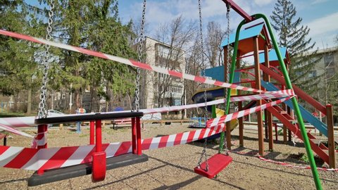 Chisinau, Moldova - March 27, 2020: Empty blaocked children playground in residential area during quarantine by reason of coronavirus AKA covid-19 virus threat. State of emergency declared in Moldova