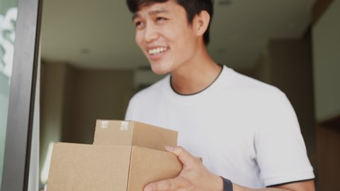 slow motion of asian man hand holding group of boxes while receiving form postman and say thank you for delivery business and transportation service concept
