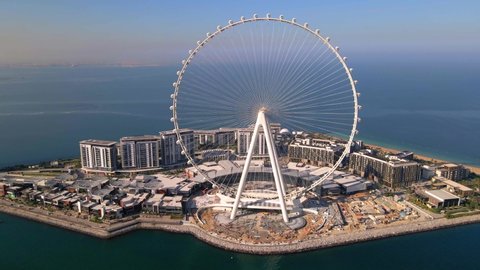Bluewaters island and Ain Dubai ferris wheel on in Dubai, United Arab Emirates aerial footage. New leisure and residential area in Dubai marina area