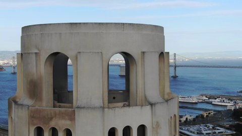 Coit Tower San Francisco drone closeup with Bay Bridge