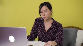 Young mixed race woman is engaged in videoconferencing while sitting at home. Work or home education concept. 4k footage