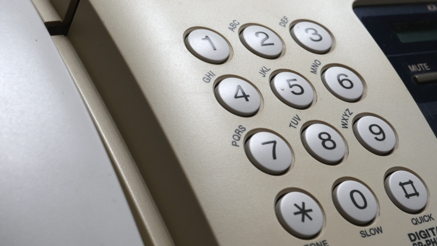 Finger Of Doctors With Blue Protection Gloves Dials On The Number Buttons On The White Fax Telephone. A Doctor
