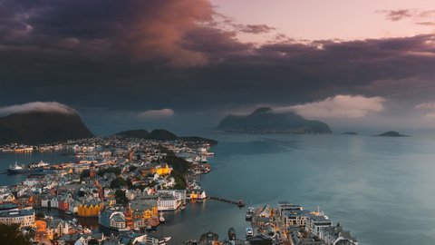 Alesund, Norway. Day To Night Time-lapse. Dramatic Sky In Warm Colours Above Alesunds Islands In Sunset Time. 4K. Famous Town In Evening Night Time.