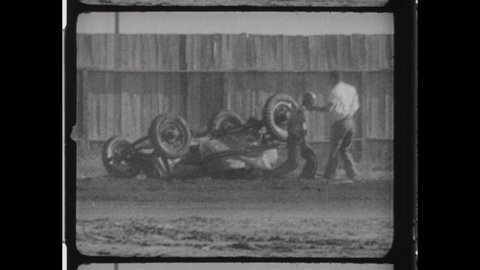 1930s Cedar Rapids, IA. Sprint Car Racing on Dirt Track. Cars Collide and One Flips End over End. The Driver Survives and Stands Up and Walks Away. 4K Overscan of Vintage Archival 16mm Film Print