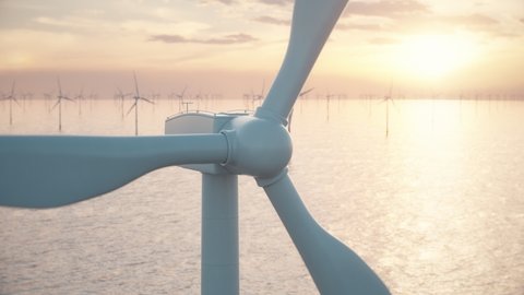 Camera moves around the head of a wind turbine to reveal an aerial view of a large wind farm in the sea against a low sun. Green and renewable energy concept. Realistic high quality 3d animation.
