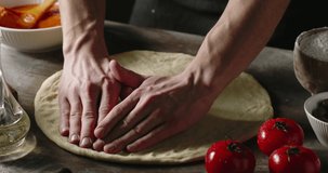 Professional chef carefully shaping dough for Italian pizza. Cooker using traditional methods to make pizza. Food and drink close up 4k footage