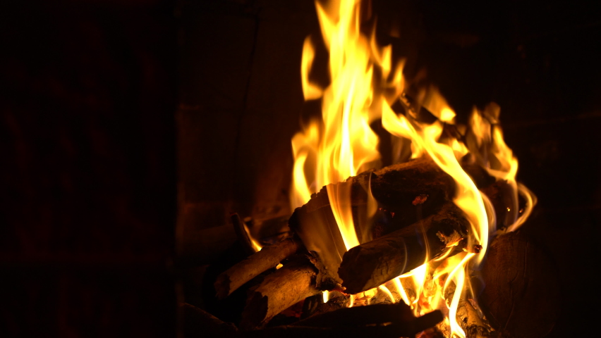 Relaxing flames at fireplace. Putting wood on fire. 4K . With a smooth camera move! | Shutterstock HD Video #1067093665
