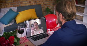 Caucasian couple on a valentines date video call man waving to smiling woman waving back on laptop screen. online valentines day during quarantine lockdown.