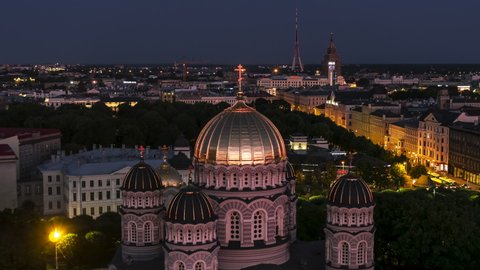 Revealing Aerial View Shot of Riga, Riga Nativity of Christ Orthodox Cathedral, Latvia at night evening