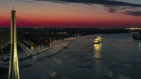 Aerial View Shot of Riga, Sunset over Daugava River, Ferry leaving city, Latvia at night evening