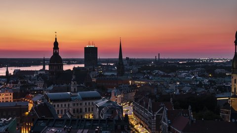 Aerial View Shot of Riga, Riga Skyline, Latvia at sunset, orange and yellow