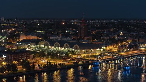 Aerial View Shot of Riga, Famous train bridge and old market, Latvia at night evening