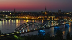 Aerial View Shot of Riga, Riga Skyline, train approaching city, Latvia at night evening