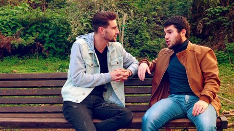 feel excluded - young man is excluded from the conversation by two friends