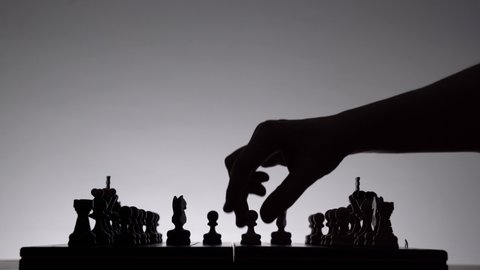 Game of chess. Board with chess pieces silhouettes on white. Concept of business ideas competition and strategy ideas. Black and White classic. Popular king's pawn opening and scandinavian defense