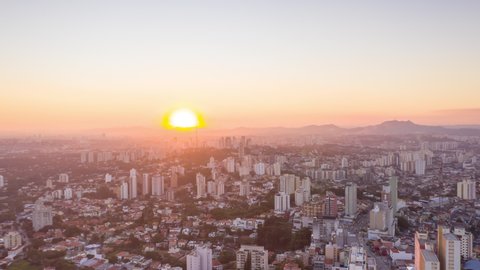 Aerial Hyperlapse of sun setting at Sao Paulo west zone. Movement of cars and clouds in the sky. Sao Paulo, Brazil.