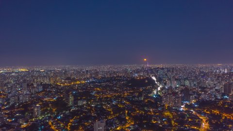 Aerial Hyperlapse of full moon rising at Sao Paulo city at night in Brazil