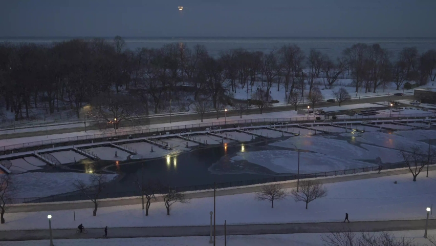 Beautiful sunset in winter, people walking while it is too cold.