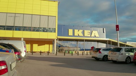 Borlange , Sweden - 10 23 2020: Vehicles and a cyclist leave a Swedish Ikea store