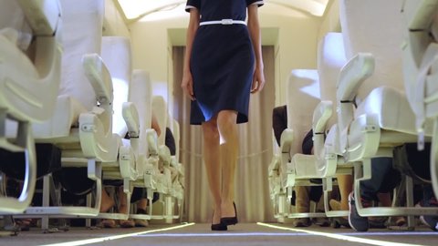 Cabin crew walking in airplane during a night flight . Airline transportation and tourism concept.