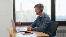 man wear wireless headphones making video conference business call on laptop speaking communicating by webcam, male teacher manager talking do online chat on computer sit at home office desk