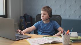 Portrait of a young boy teaching lessons online at a distance using laptop and internet via video chat. Distance learning at home. - Powered by Shutterstock - Get 15% off with code: PIKWIZARD15
