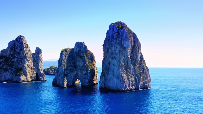 Orbiting shot of the three famous Faraglioni rocks off the Capri island, well-known all over the world Royalty-Free Stock Footage #1067129476