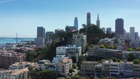 San Francisco, CA, USA. Aerial footage of the Coit Tower and Golden Gate Bridge. Dense building of business quarter as seen from above. High quality 4k footage