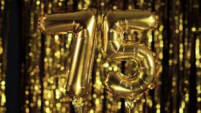 The golden number 75 seventy five is made from an inflatable ball on a yellow background. One of the complete set of numbers. Birthday, anniversary, date concept - Powered by Shutterstock - Get 15% off with code: PIKWIZARD15
