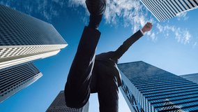 Japanese businessman jumping in the city center - Powered by Shutterstock - Get 15% off with code: PIKWIZARD15