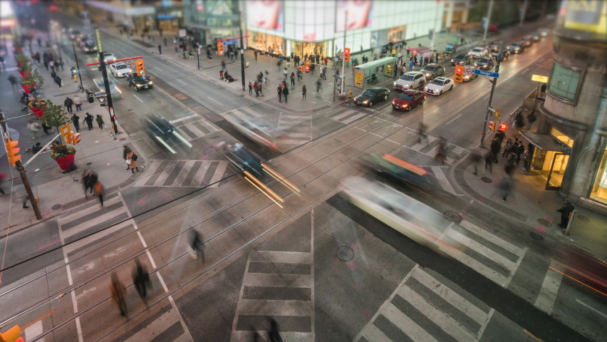 Toronto, Ontario, Canada, time lapse view of traffic and pedestrians crossing busy intersection at Yonge and Dundas Square. Royalty-Free Stock Footage #1067134780