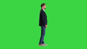 Handsome man in a suit pushing virtual buttons presenting something on a Green Screen, Chroma Key. - Powered by Shutterstock - Get 15% off with code: PIKWIZARD15