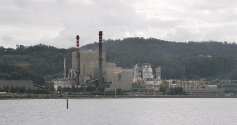Pontevedra, Spain; october 15, 2020: View of ENCE paper mill factory on Ria de Pontevedra, Galicia Spain. Timelapse