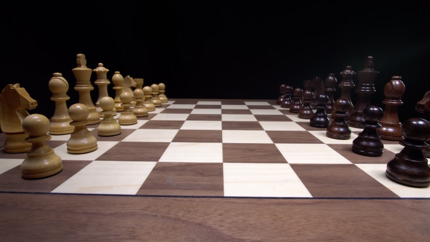 Confident chess master moves played on a premium wooden tournament chess board. The Sicilian Chess Defense.