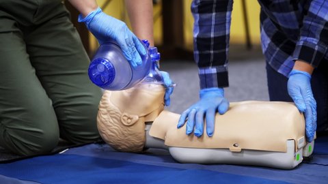 Exercise for life saving in emergency. Demonstration of CPR on manikin. Teaching method pressing on the chest on a dummy in the medical room.