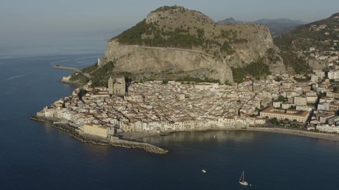 Aerial view at sunset of the ancient village of Cefalù, Sicily, Italy. Cefalù is one of the main tourist attractions of Sicily. The Rocca of Cefalu is famous and picturesque.