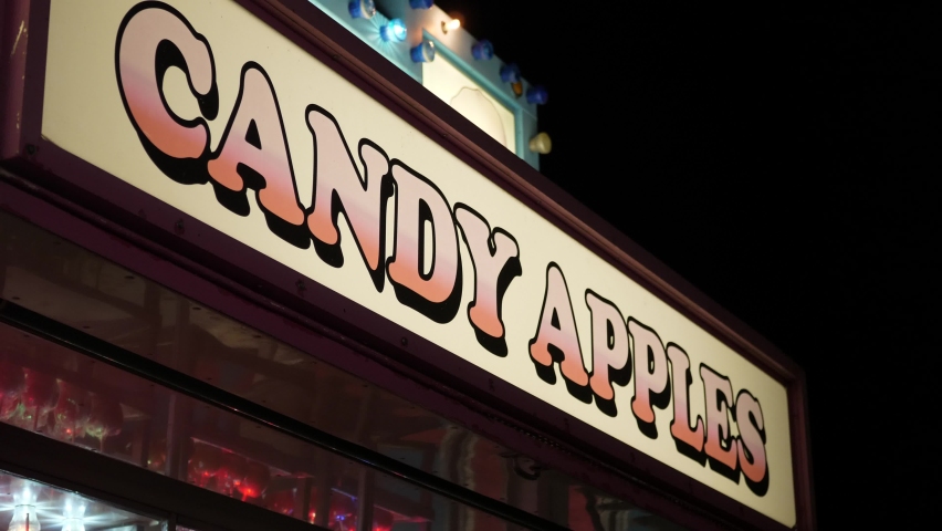 A candy apple sign at a carnival at night | Shutterstock HD Video #1067173777