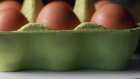 fresh eggs in the egg carton with movement