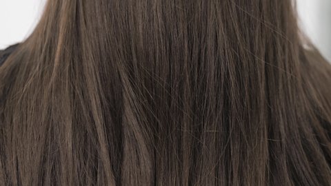 Demonstration of the brunette's hair before straightening it. Brittle tangled brunette hair. High quality 4k footage