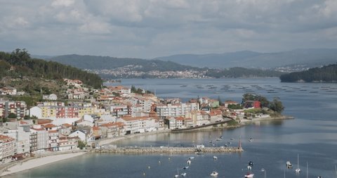 Panoramic view of Ria de Pontevedra, Galicia, Spain and Raxo town at foreground and Marin harbor at background on sunny day. Beautiful seascape of Galicia
