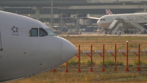 FRANKFURT AM MAIN, GERMANY - JULY 20, 2017: The Airbus A340 is pulled by a tug at the International Airport in Frankfurt. Airplane nose and cockpit view