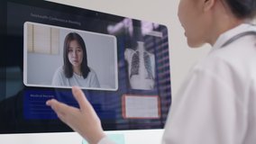 Attractive beautiful asia chinese female doctor video conference call online live talk follow up remotely in medical coronavirus result with patient at office. Online telehealth telemedicine service.