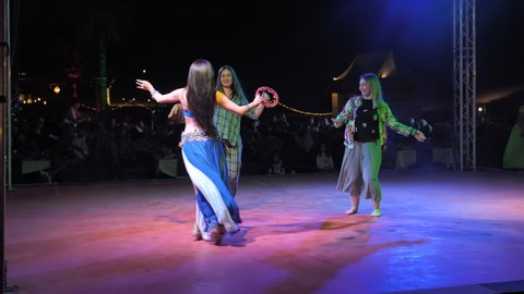 Dubai, UAE - December 14, 2019: Oriental arab belly dancing in the desert of Dubai.