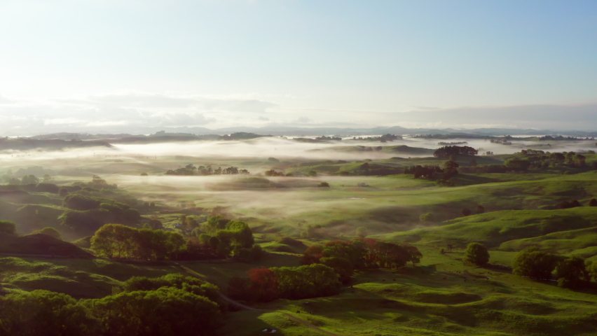 Morning Fog Over Green Fields And Hills In Te Arai, North Island Of New Zealand. - aerial