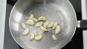 Frying garlic with oil in a saucepan