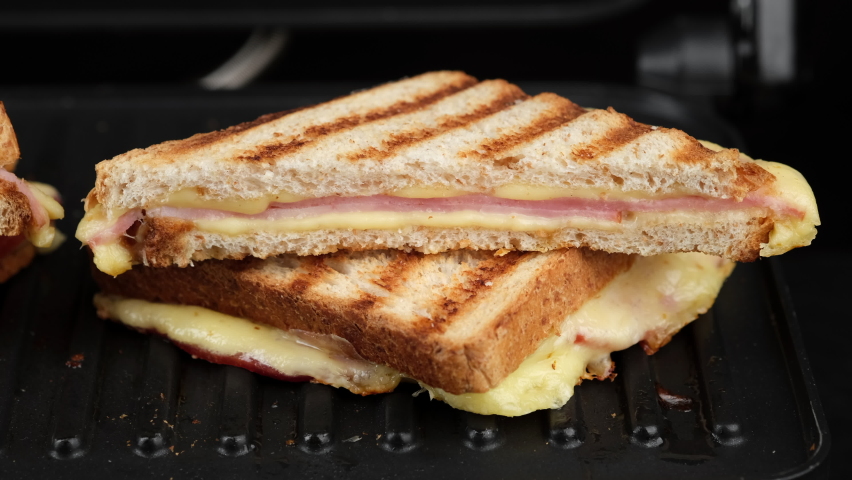 Sandwich with cheese and ham on grill. grilled cheese sandwich close up | Shutterstock HD Video #1067199031