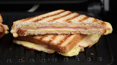 sandwich with cheese and ham on grill. grilled cheese sandwich close up