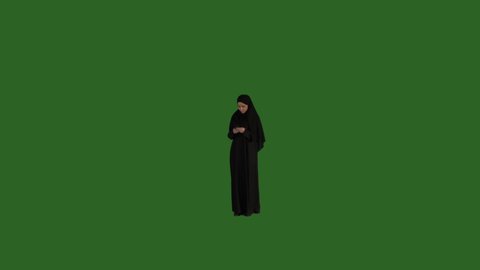 Green screen Arab Saudi woman using her phone, sending messages on a green screen, middle eastern woman on green screen, KSA woman with green screen background, mobile, cellphone