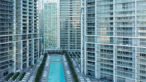 Cinematic design glass and concrete apartment buildings in prestige residential area, 4K. Modern architecture of downtown Miami, aerial view. Contemporary urban cityscape view, drone b roll footage