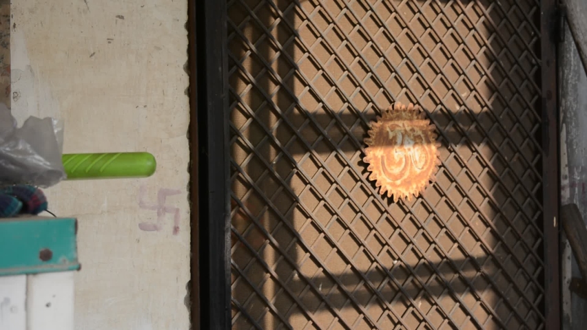 a young man opening a metallic door and coming outside